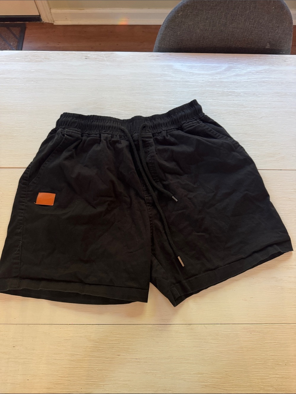 Amazon Men's Black Athletic Shorts with Orange Patch
